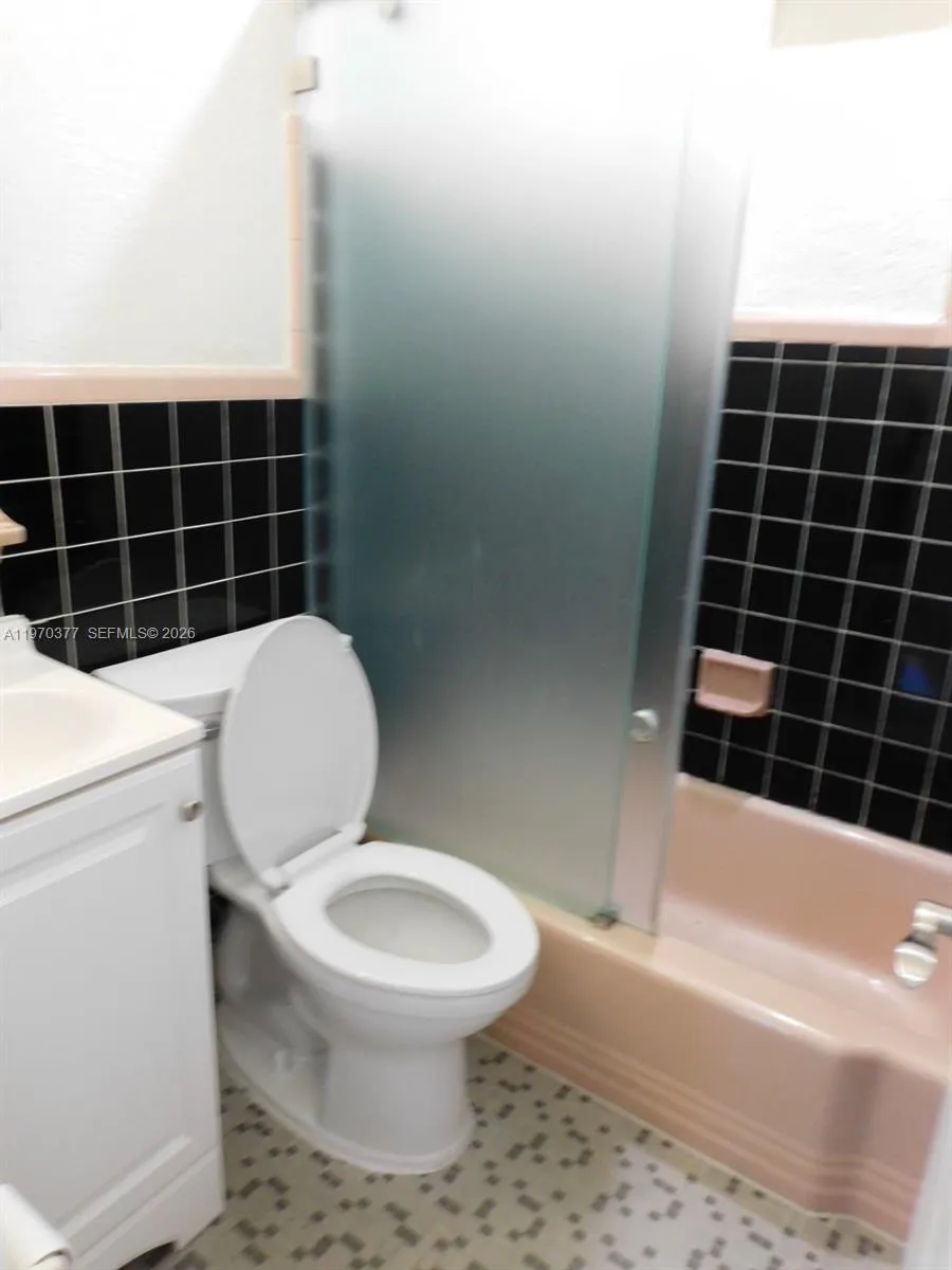 2nd bathroom with newer vanity and toilet.