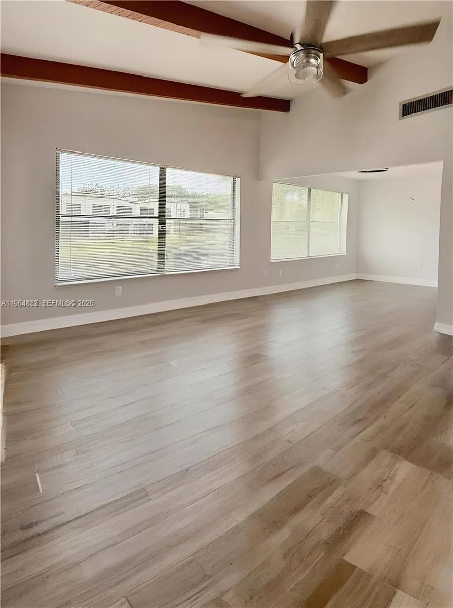 AI-adjusted image with furniture removed to highlight the room’s size and lines.