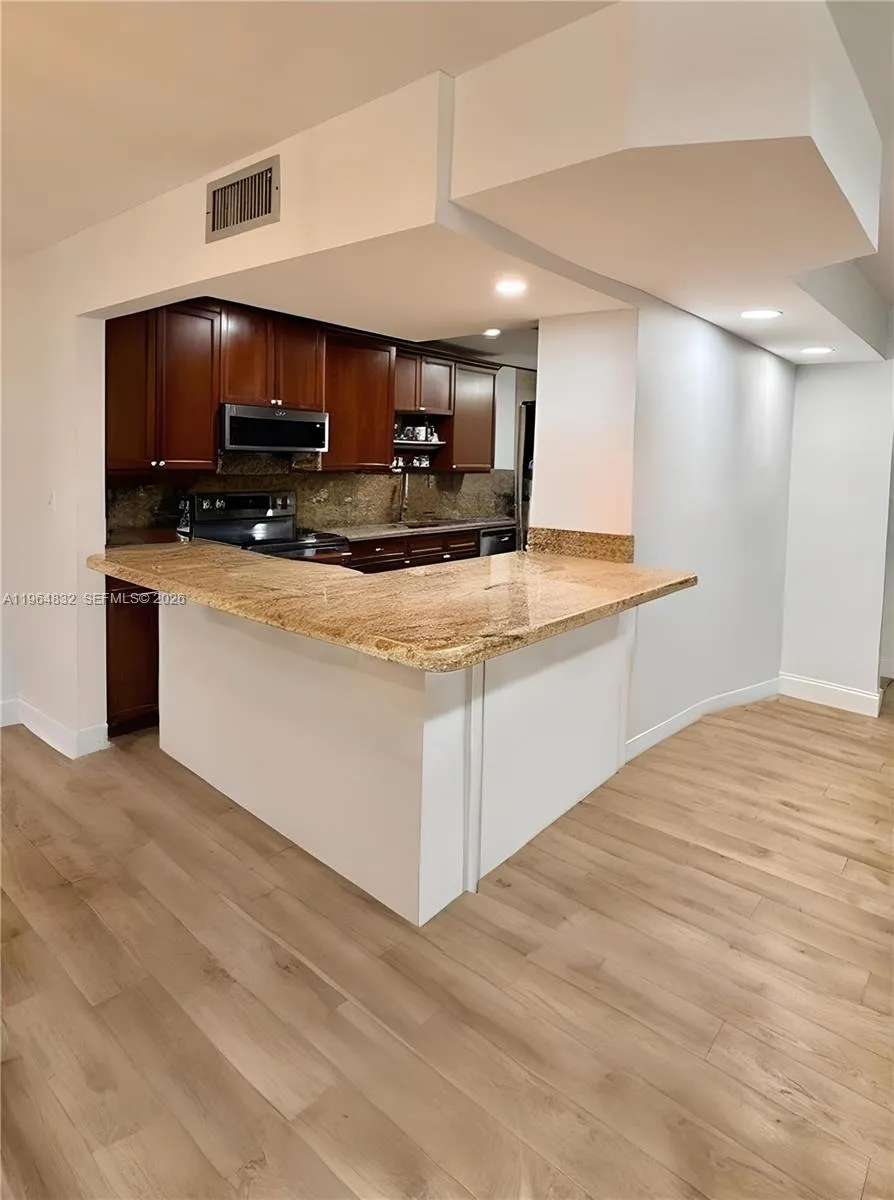 AI-adjusted image with furniture removed to highlight the room’s size and lines.