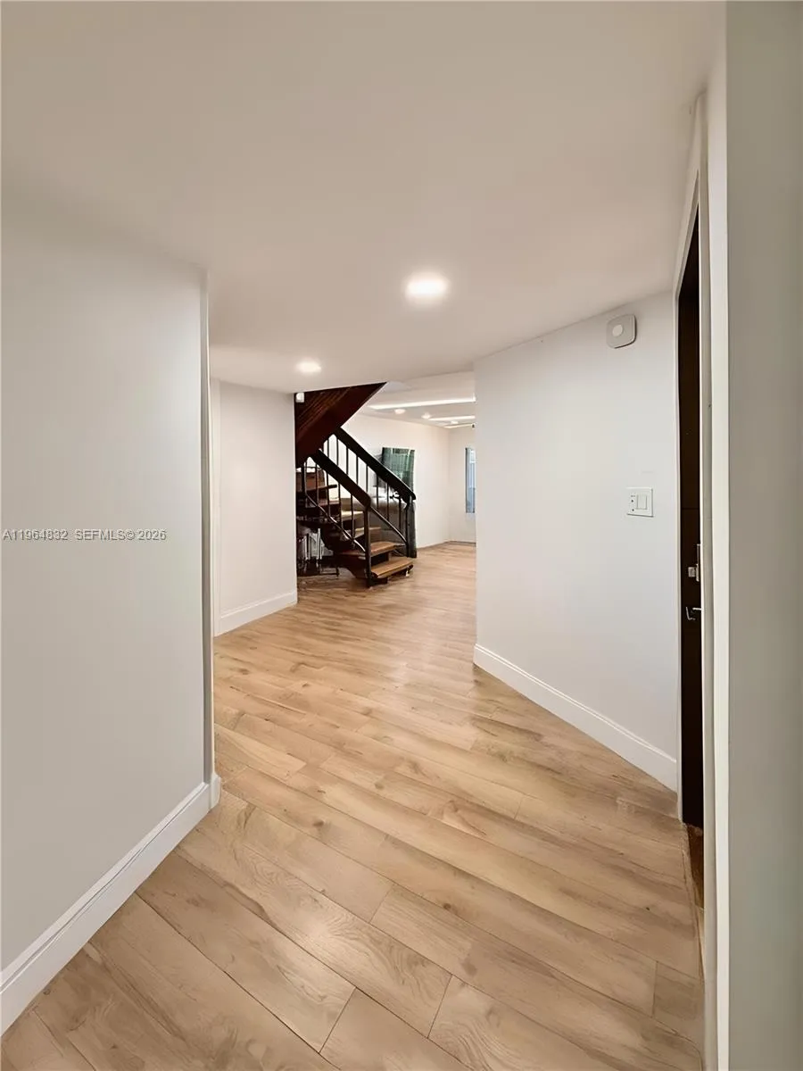 AI-adjusted image with furniture removed to highlight the room’s size and lines.