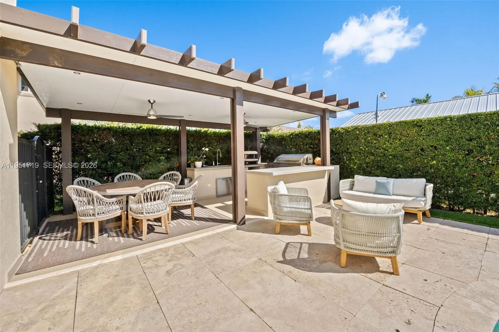 The residence showcases modern architectural elements including clean geometric lines, elegant rain chains, and a recessed grand entrance.
