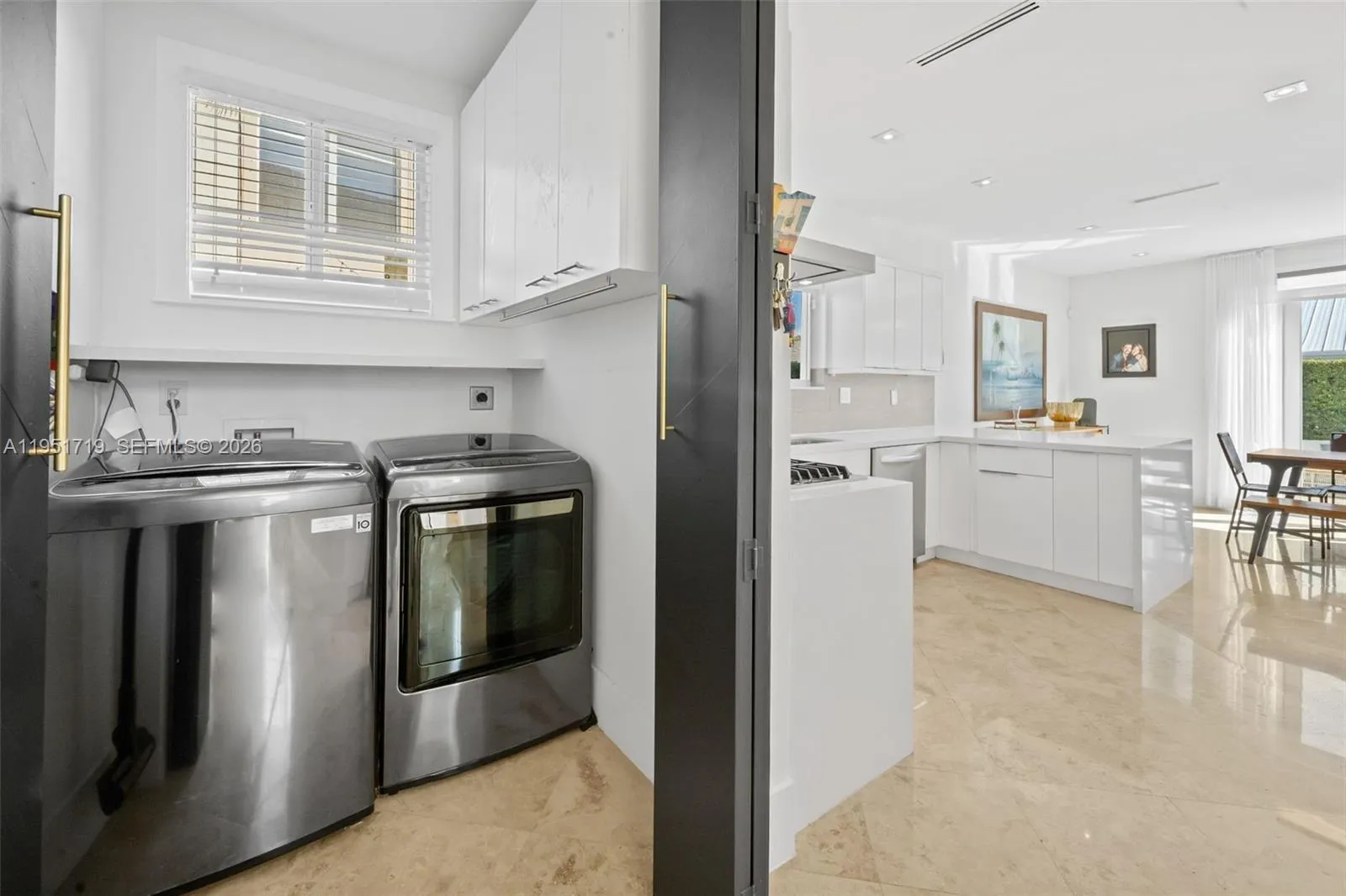 The expansive primary suite is a true retreat, featuring warm wood flooring, a designer accent wall, and large windows that fill the space with natural light.