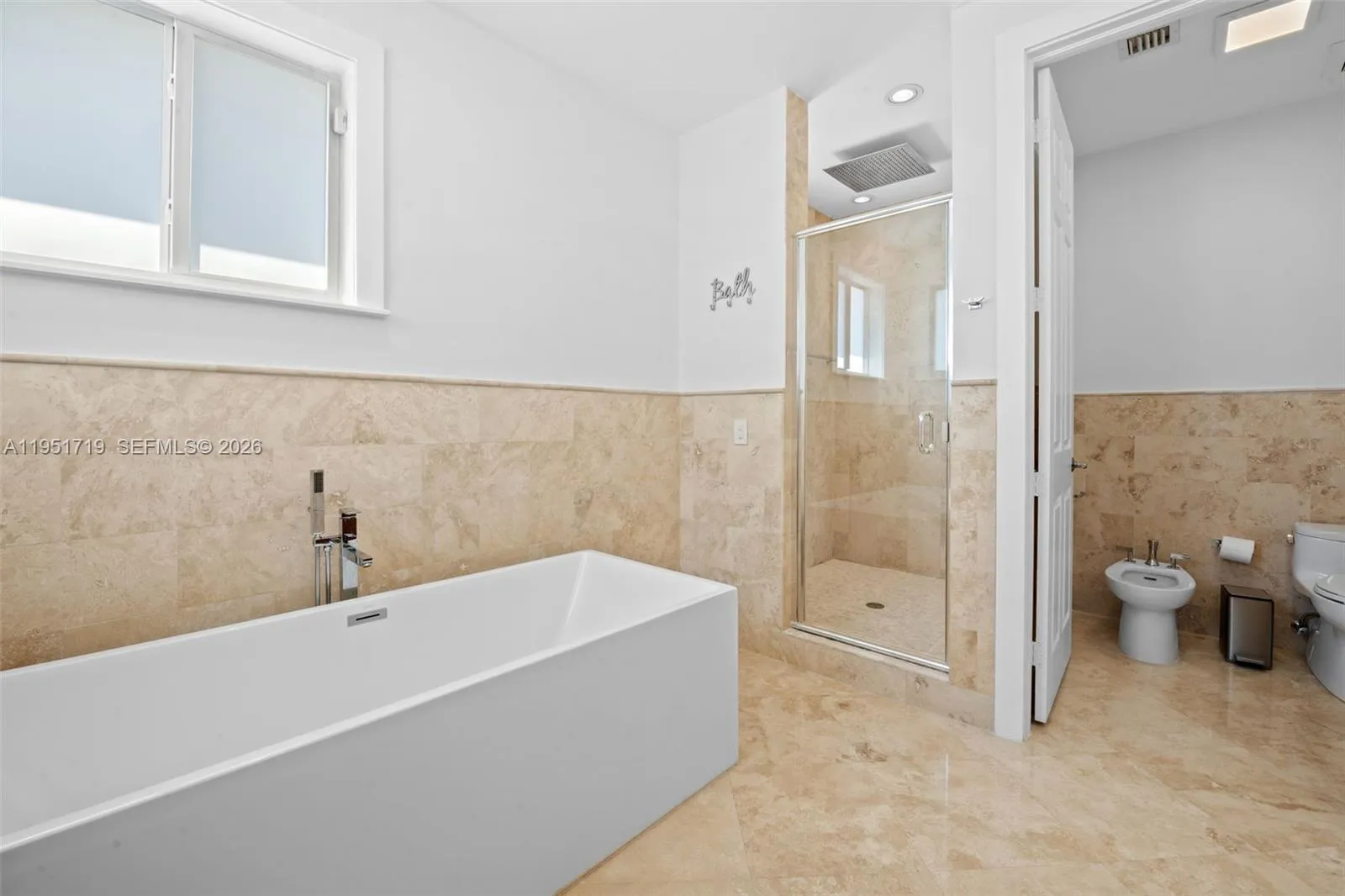 A well-appointed second bath features a modern vanity with a vessel sink and a designer-tiled walk-in shower.