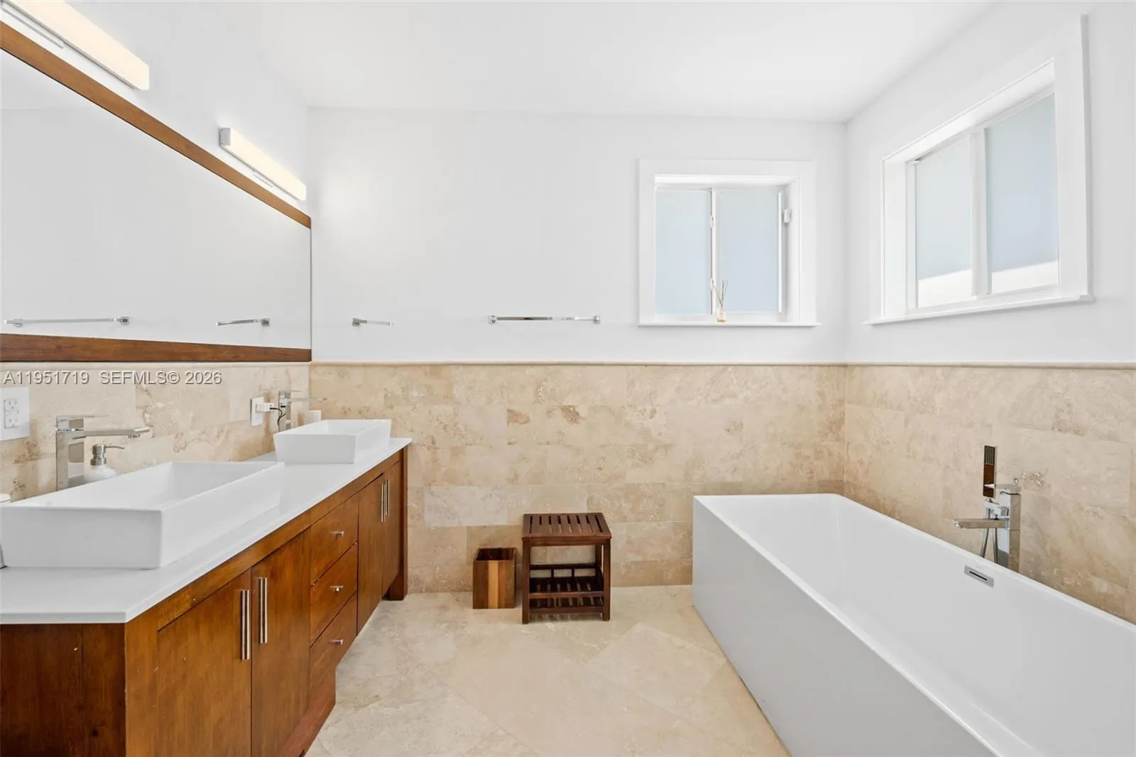 This bright and spacious guest room offers private balcony access, wood flooring, and a large reach-in closet for ample storage.