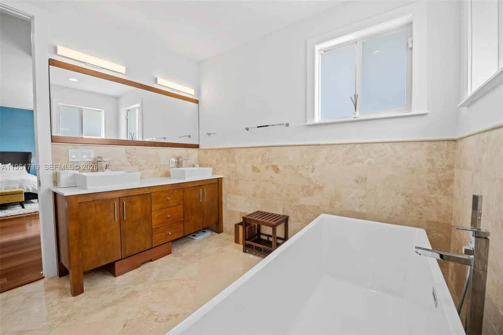 The room’s clean lines and neutral tones provide a versatile space, perfect for family members or guests.