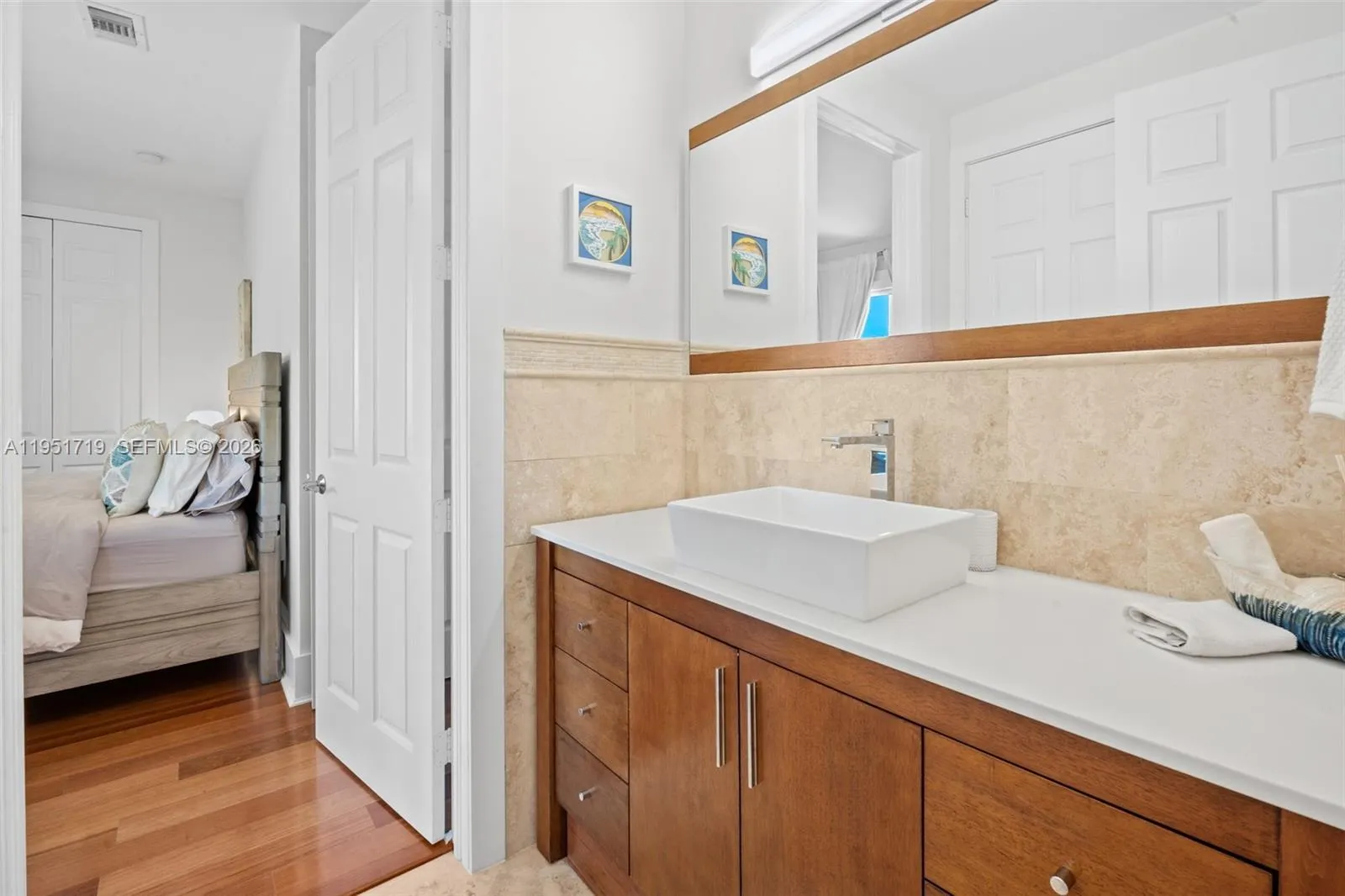 This versatile workspace is outfitted with custom charcoal-toned built-in cabinetry, dual workstations, and a hidden Murphy bed for guests.