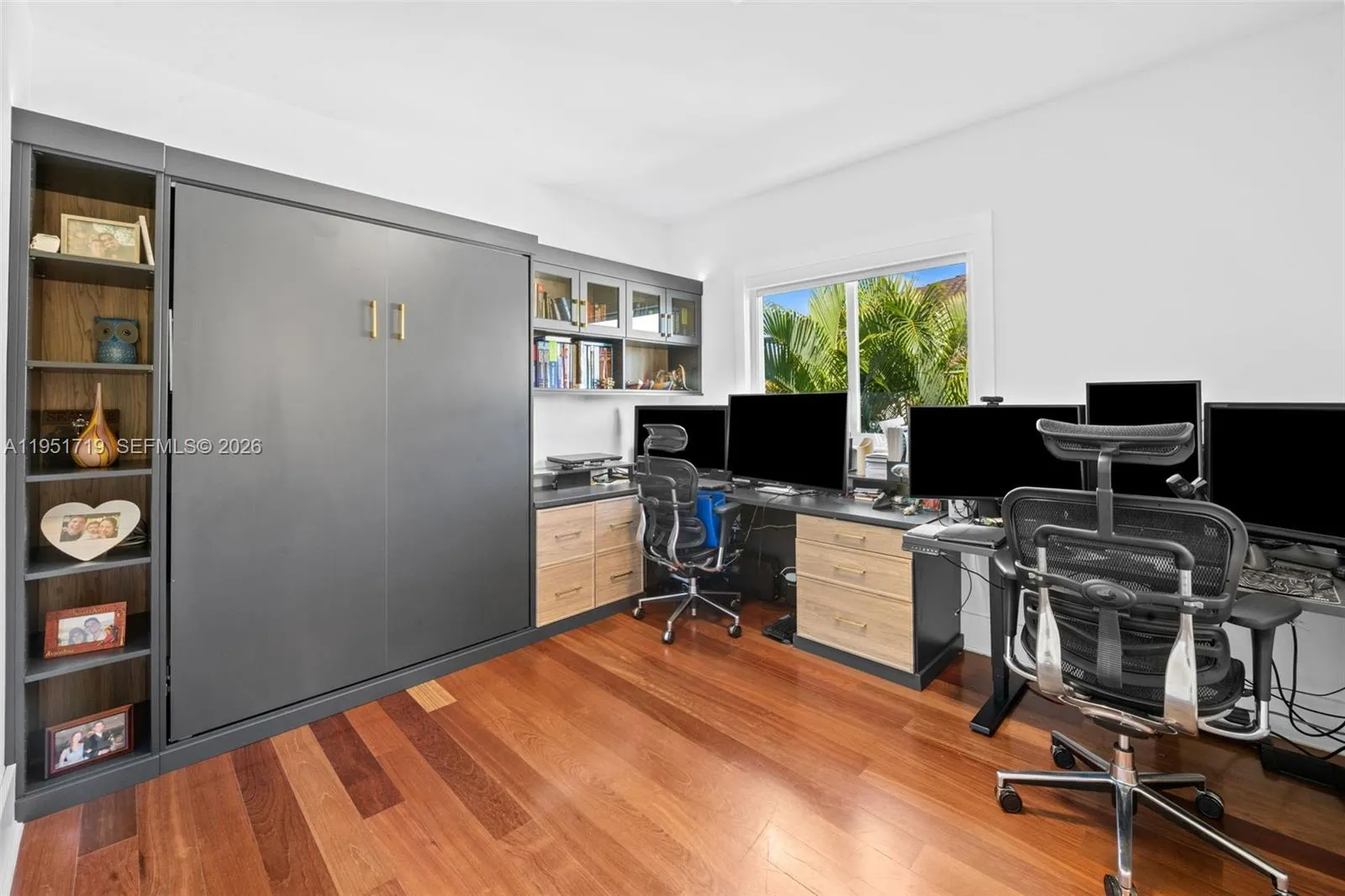 This expansive, light-filled living area features soaring ceilings and a seamless open-concept flow into the foyer.