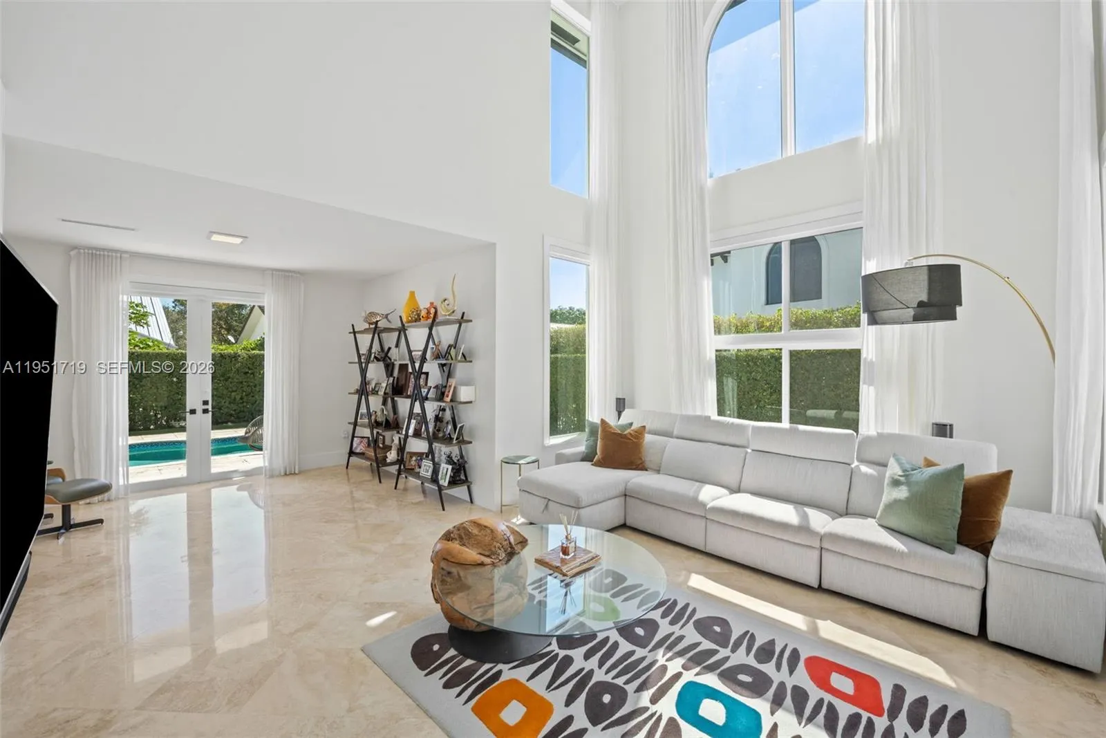 The freeform turquoise pool is surrounded by ample space for outdoor lounging and enjoying the Florida sun.