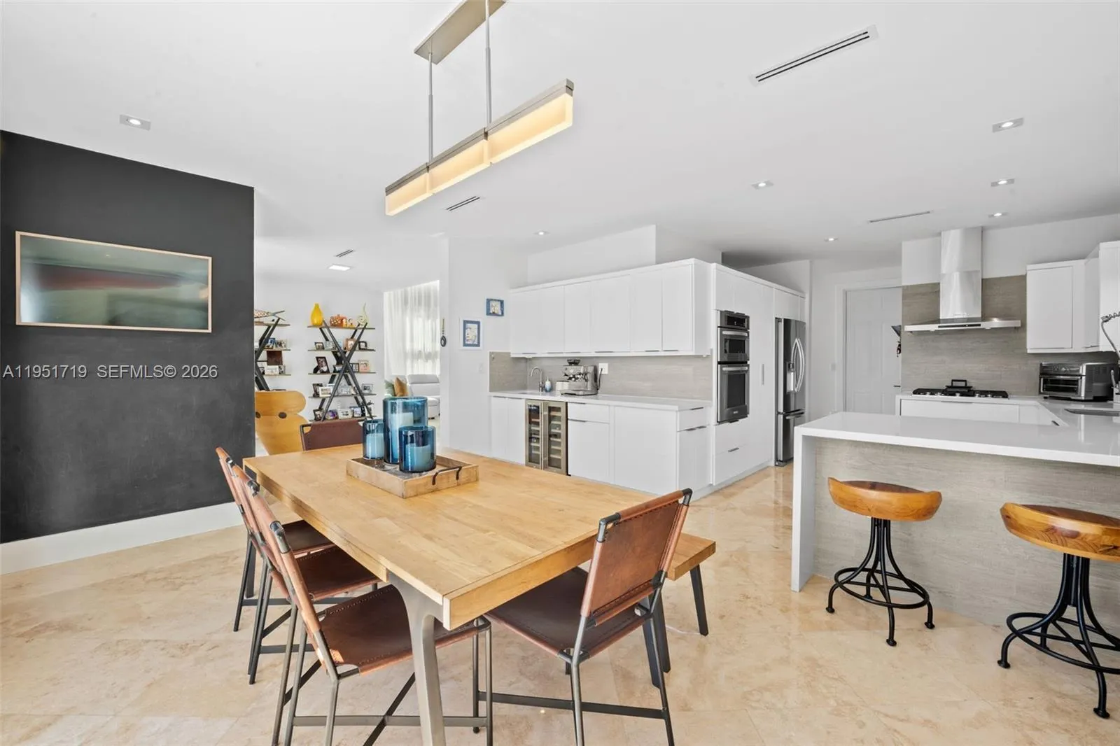 The dedicated utility space features high-capacity, front-loading machines and organized overhead storage for maximum efficiency.