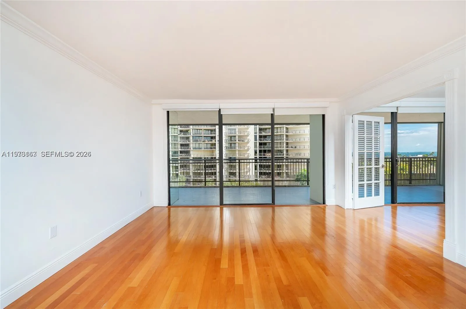 Living area. To the right is the double doors to the 2nd bedroom