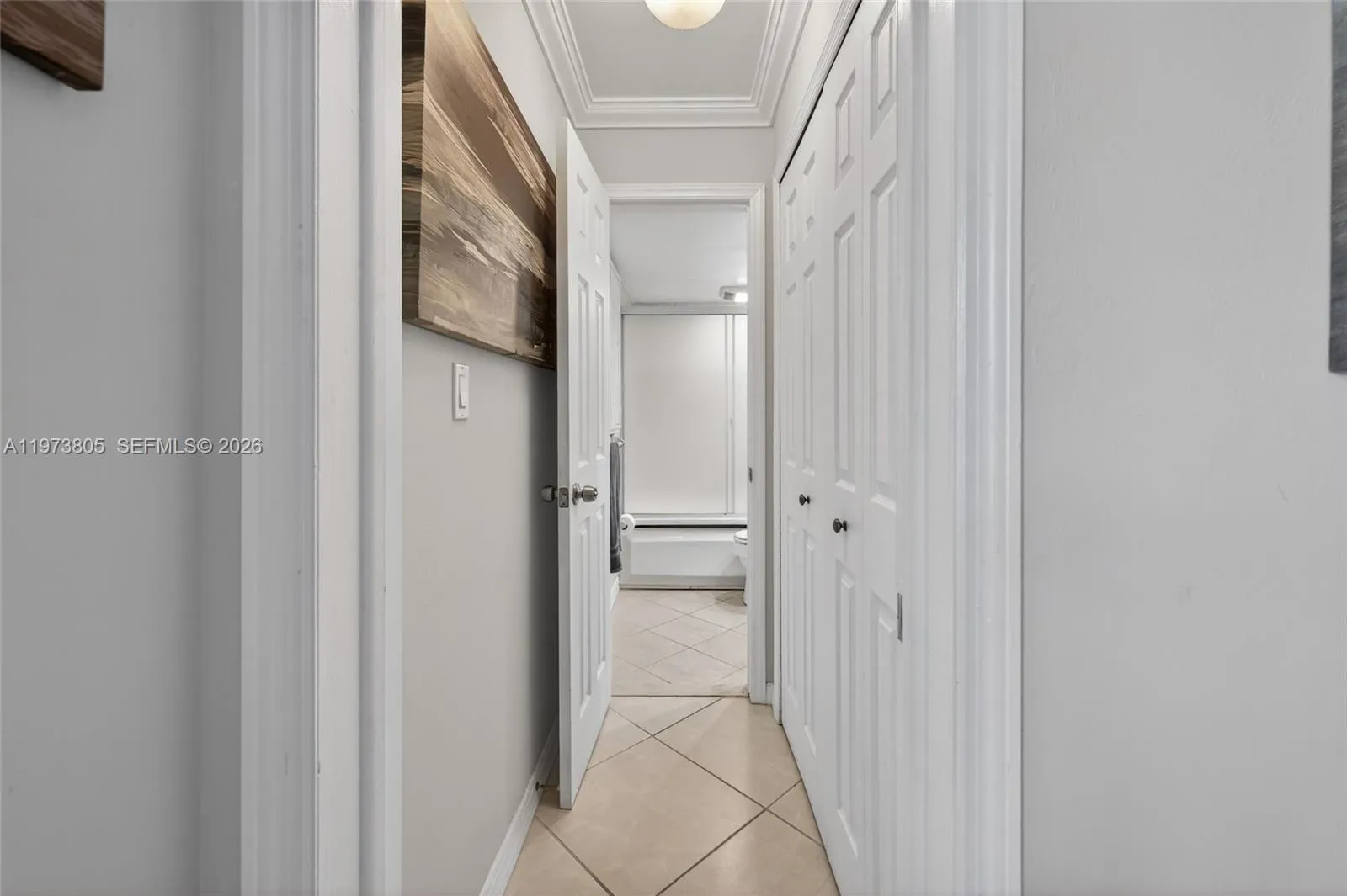 Hallway with storage and entrance to second bath