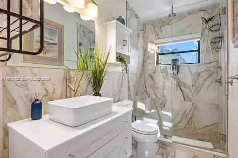 Spa-like bathroom with dramatic marble walls!