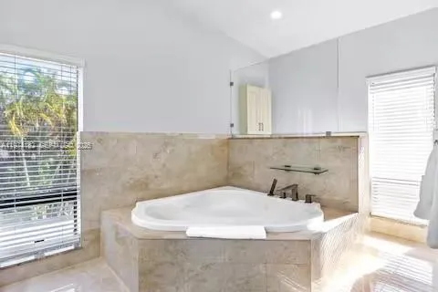 Spa-style soaking tub with garden window views!