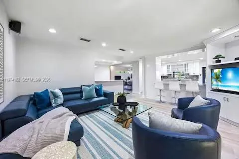 This sleek open-concept living space proves that blue is the new black