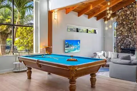 Paradise meets pool hall in this stunning game room with tropical views and a championship-worthy table!