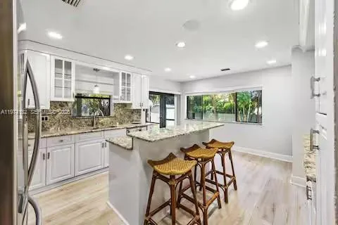Chef\'s dream kitchen where white cabinets meet granite glamour!