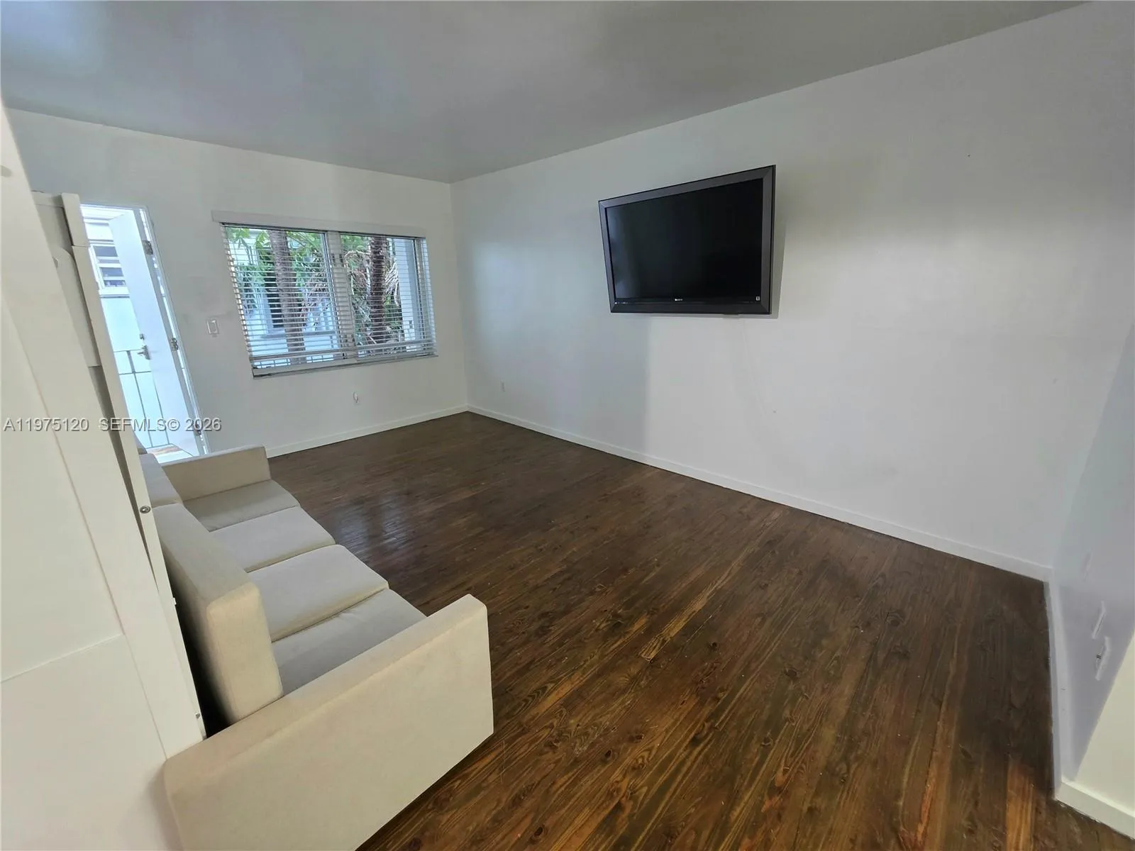 Main area living-bedroom area. Murphy bed and wall TV