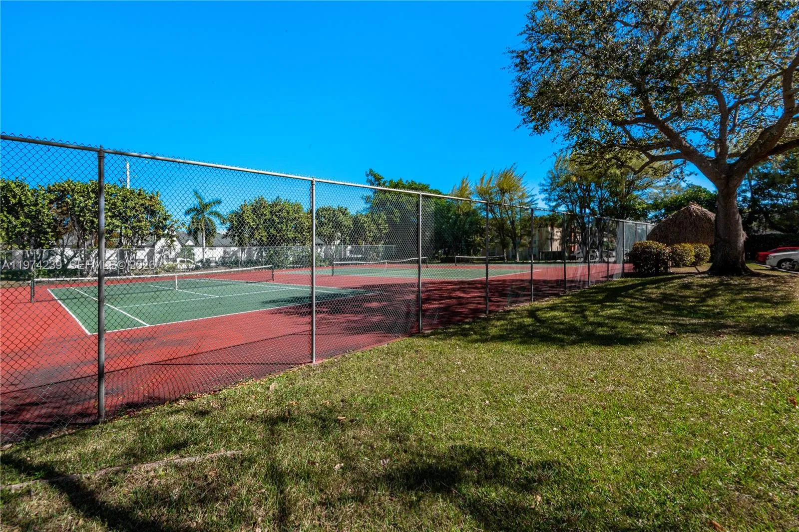 The tennis court also has a Chickee shown near the tree.