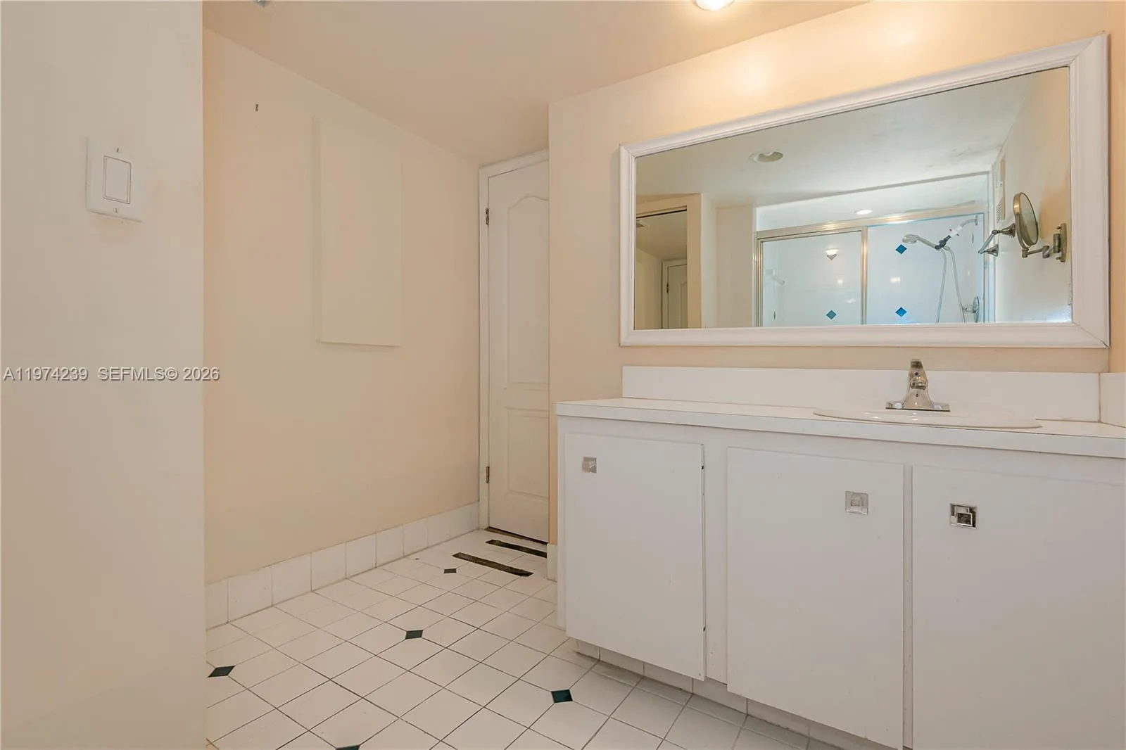 The 2nd bathroom is in the hall off the living room. There is a vanity below the sink for storage.