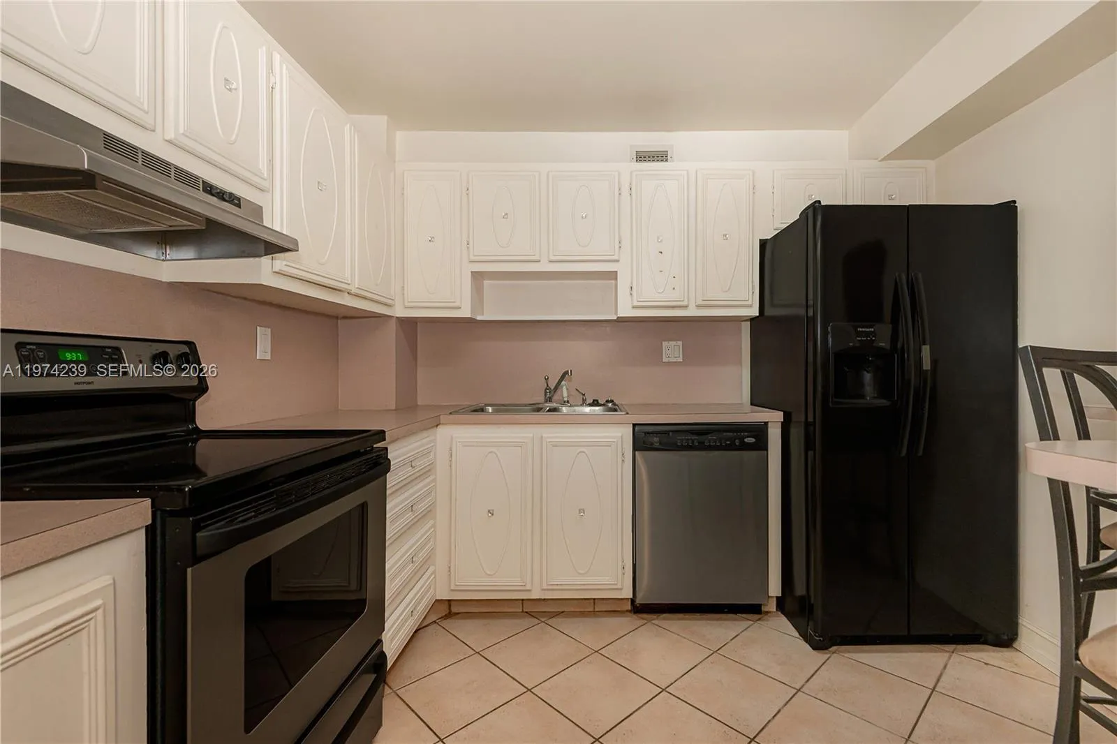 Overall view of the dishwasher, stove and refrigerator.