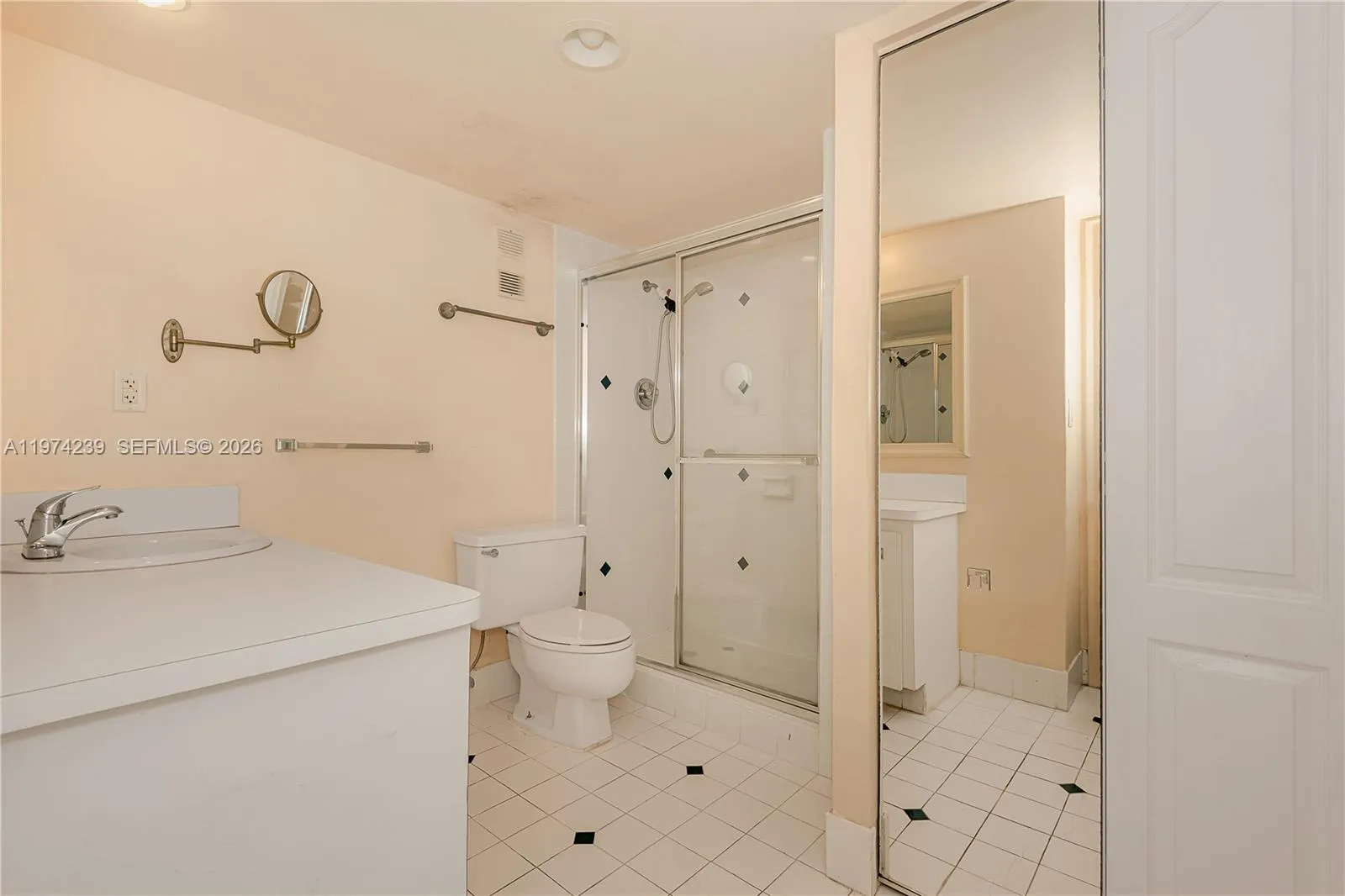The 2nd bathroom is in the hall off the living room. There is a vanity below the sink for storage.