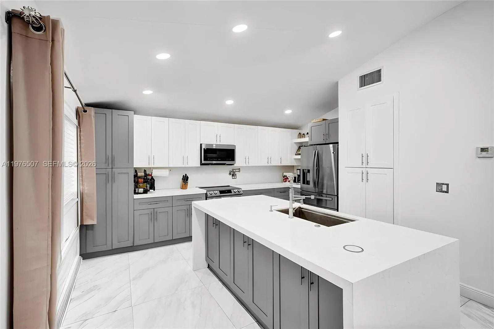 ISLAND KITCHEN WITH QUARTZ COUNTERTOPS PROVIDES PLENTY OF SPACE FOR COOKING FOR YOUR FAMILY OR FOR A BIG DINNER PARTY!