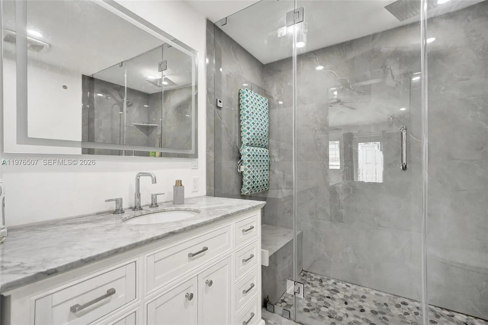 UPGRADED BATHROOM FEATURING A STATE OF THE ART SHOWER WITH A RESTING BENCH!