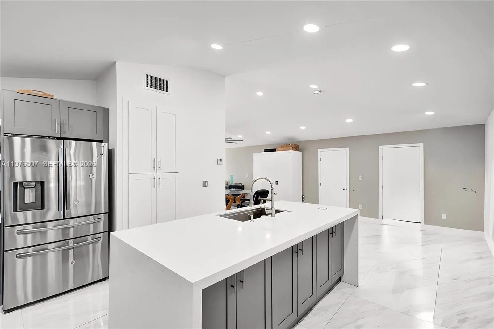 ISLAND KITCHEN WITH QUARTZ COUNTERTOPS PROVIDES PLENTY OF SPACE FOR COOKING FOR YOUR FAMILY OR FOR A BIG DINNER PARTY!