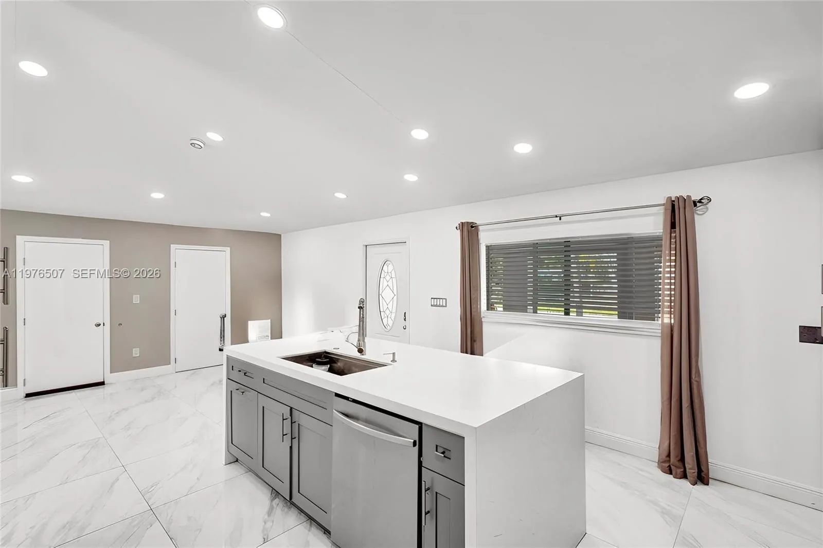 ISLAND KITCHEN WITH QUARTZ COUNTERTOPS PROVIDES PLENTY OF SPACE FOR COOKING FOR YOUR FAMILY OR FOR A BIG DINNER PARTY!