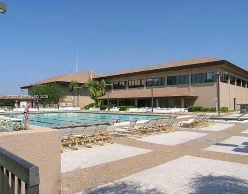 STUNNING CLUBHOUSE LAKEFRONT OUTDOOR POOL w/ PLENTY OF LOUNGING AREAS