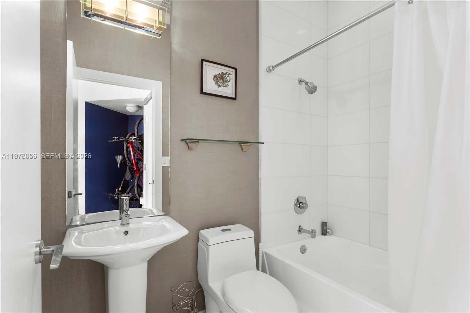 Guest bathroom with pedestal sink and tub shower