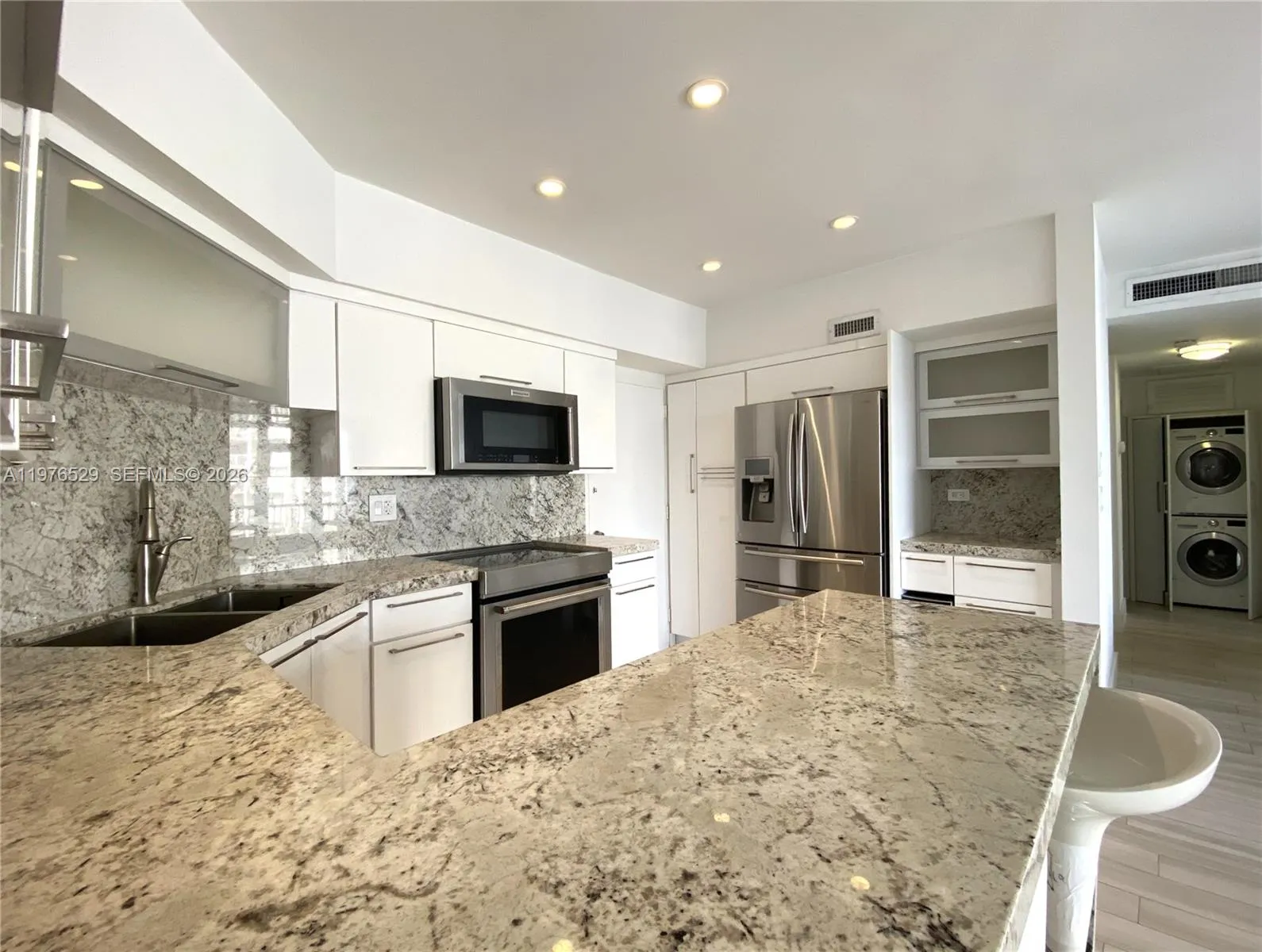 Granite Counter Top - Double Sink - Disposal - Recessed Lighting - Stainless Steel Appliances - Induction Stove - Microwave - Pantry - Vent less Washer & Dryer