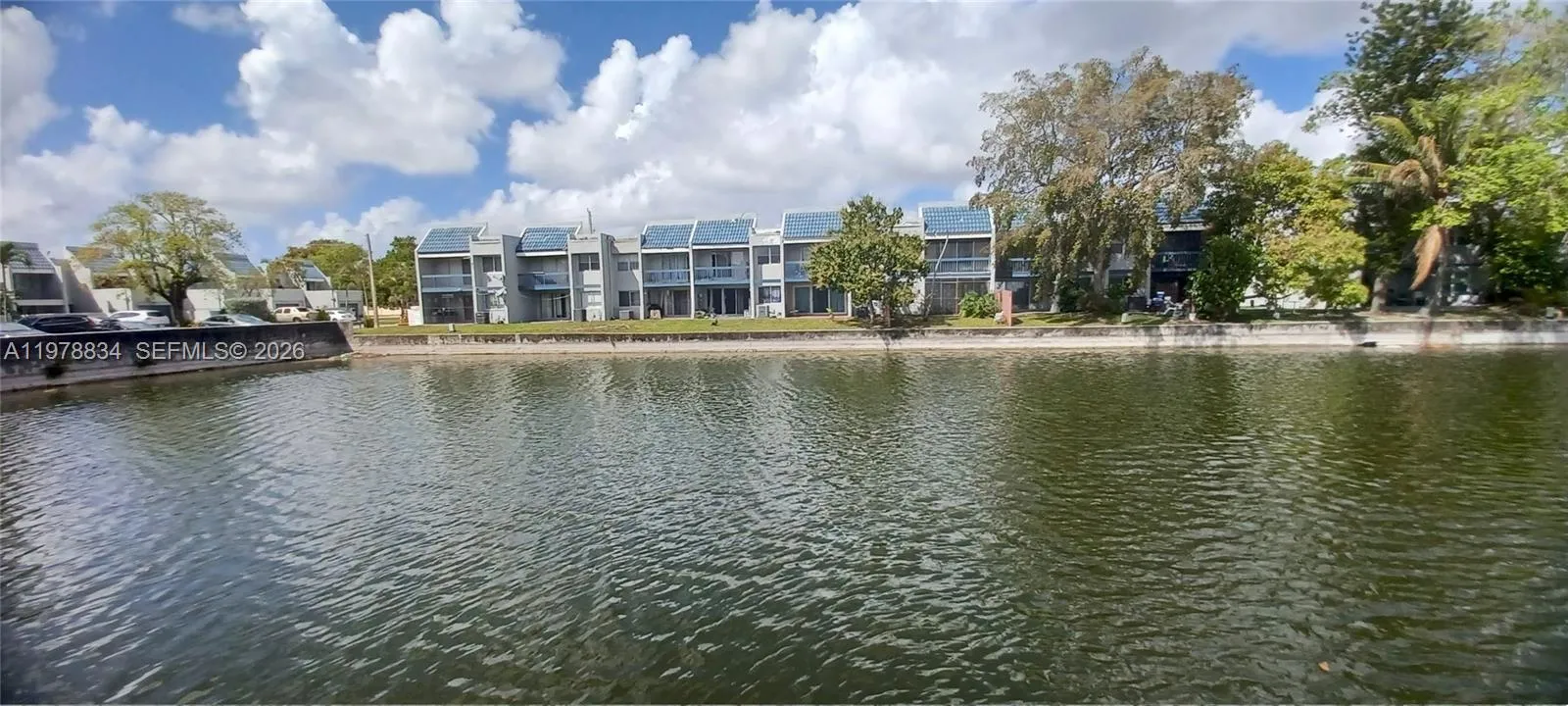 Townhome rear exterior with direct views of the community lake