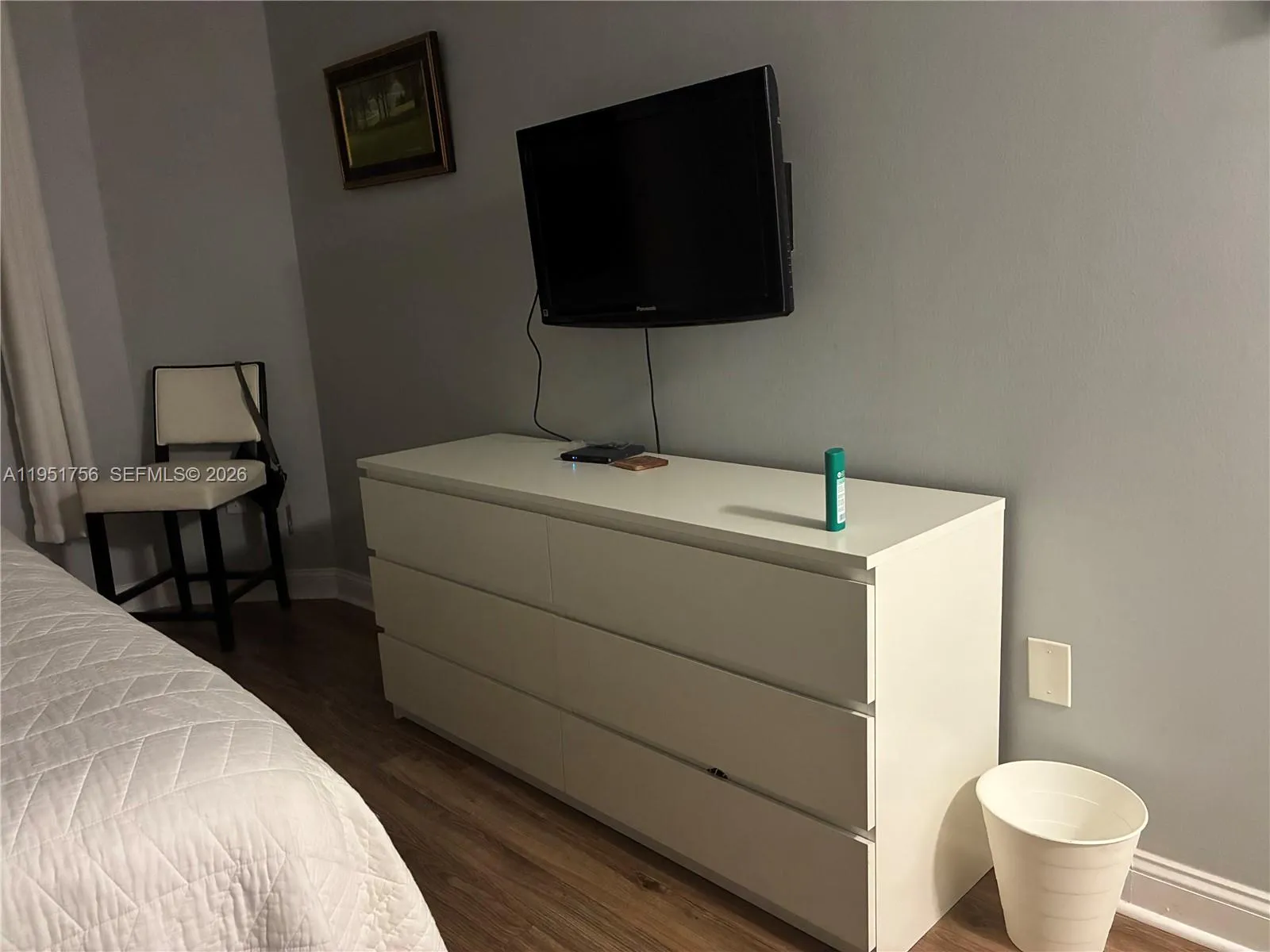 a TV on the wall with a sitting area nearby ..plenty of room to do this or that