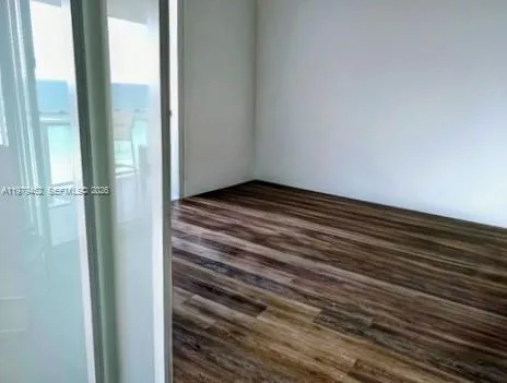 third bedroom with glass partition sliding door, walk-in closet and direct ocean views