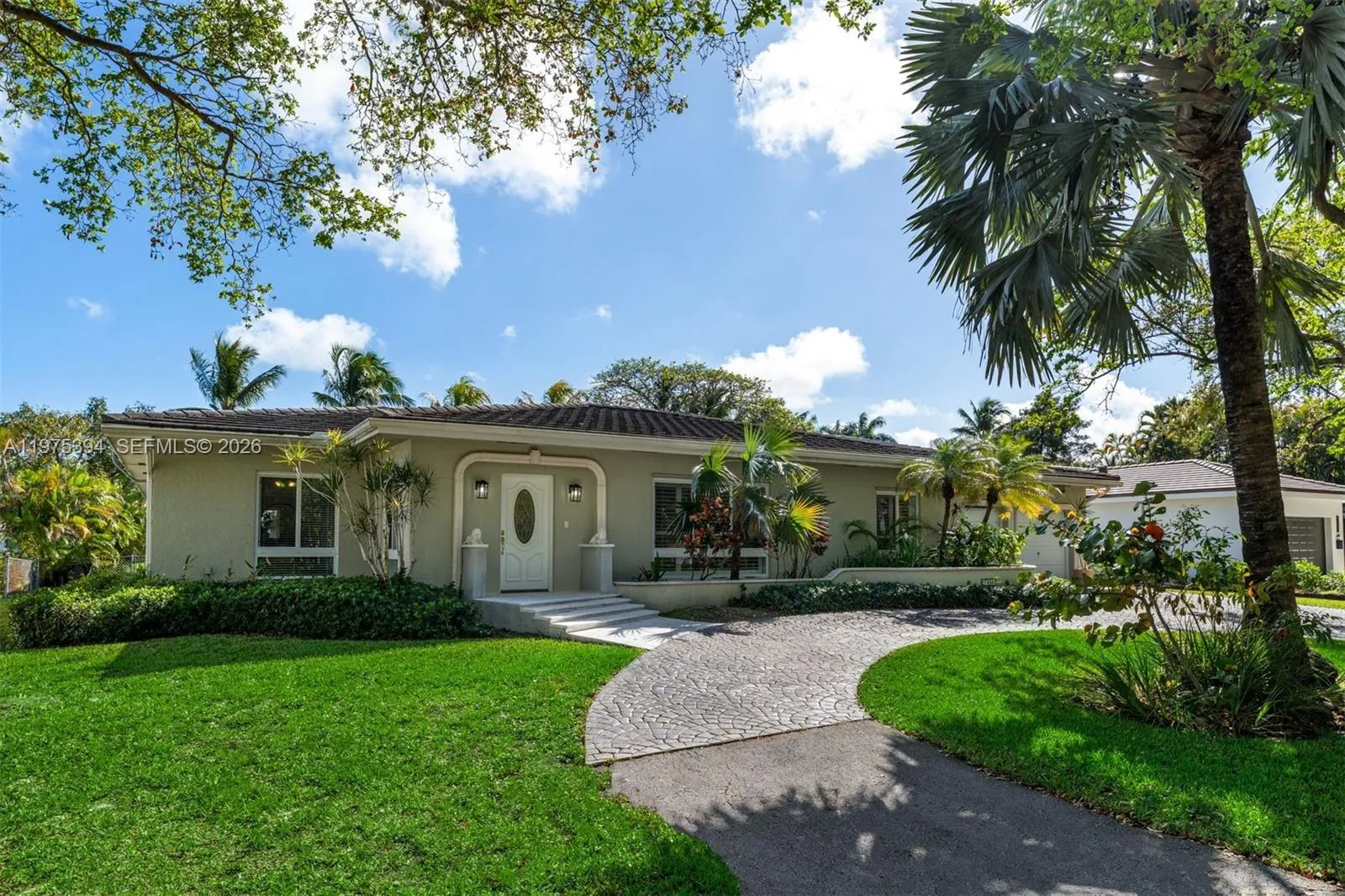 Circular brick driveway with two car garage