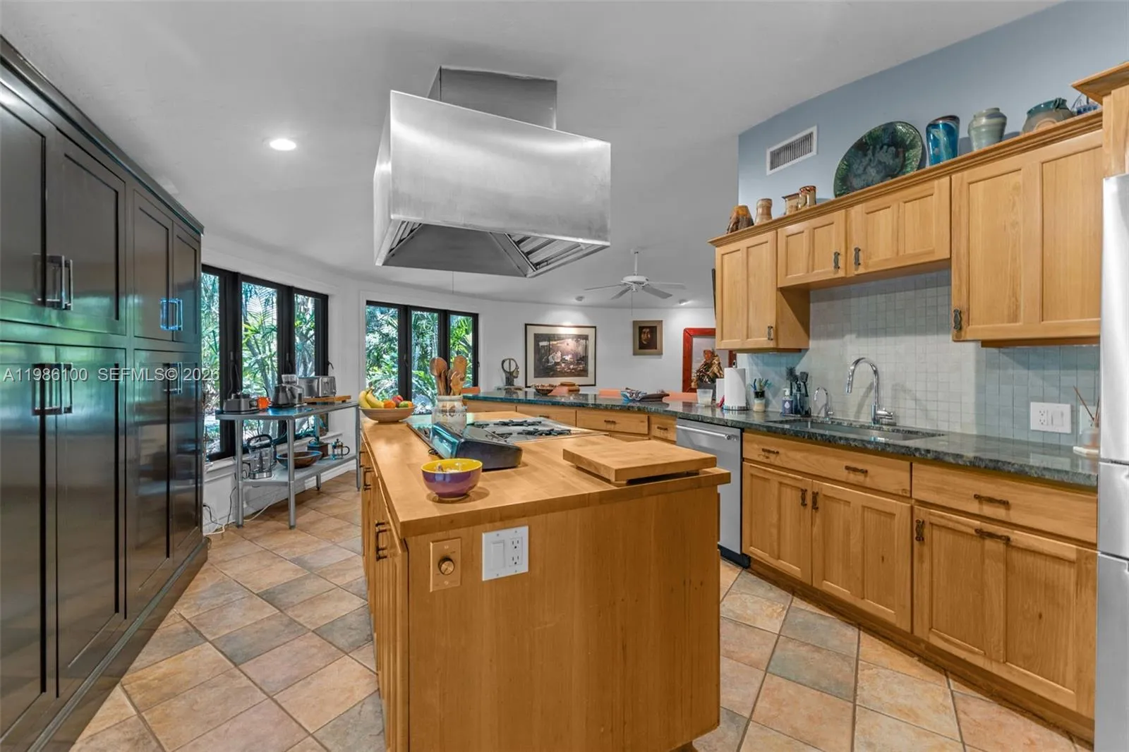 THE KITCHEN AREA OPENS TO COVERED BREEZEWAY LEADING TO GUEST WING. A PERFECT SPOT FOR  GATHERING.