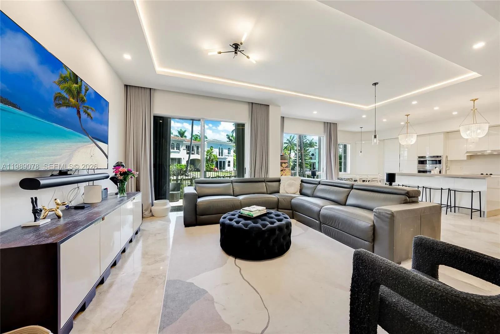 Beautifully updated open concept living room with, high ceilings and LED accent lighting in coveted Aventura Lakes