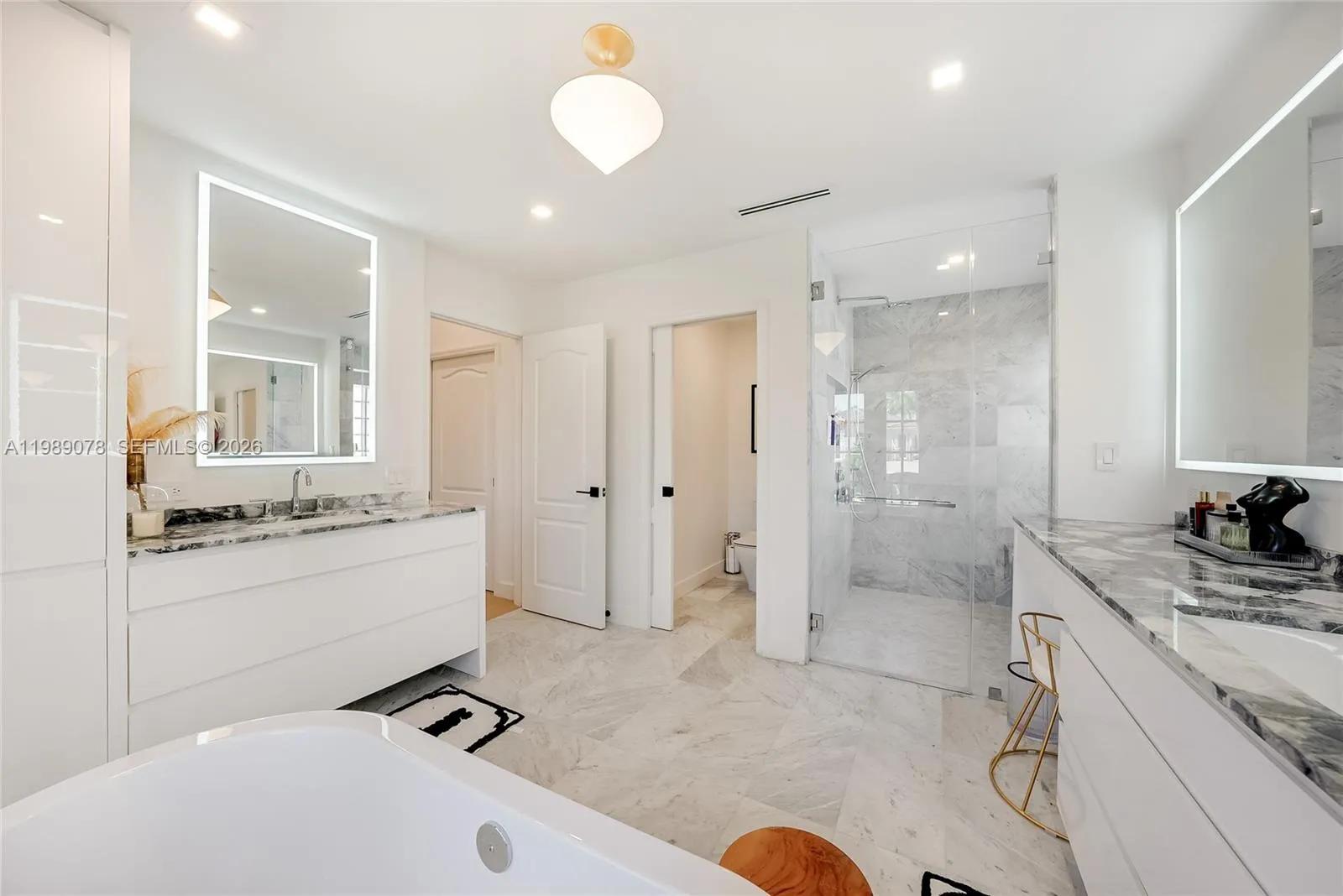 Primary spa like bath offers marble, expansive walk in shower, double vanity and separate bathtub
