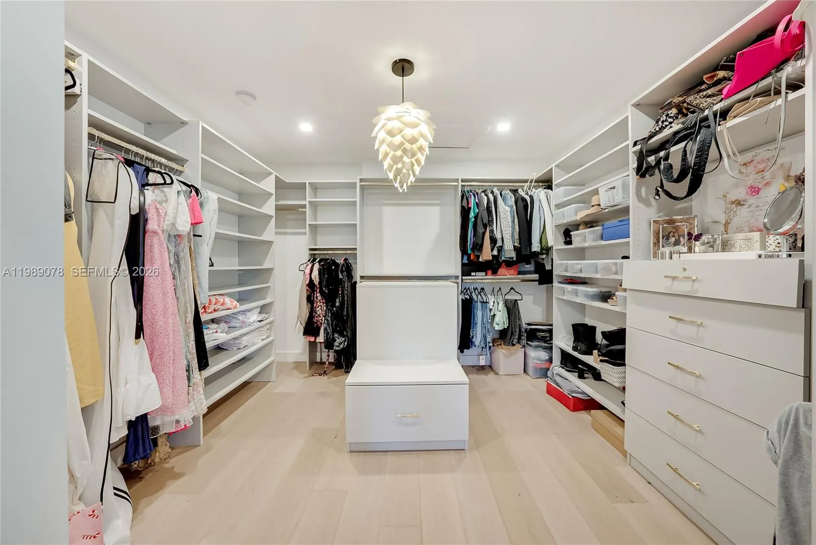Boutique like closet in primary bedroom offers space for an island or seating for a luxurious dressing area