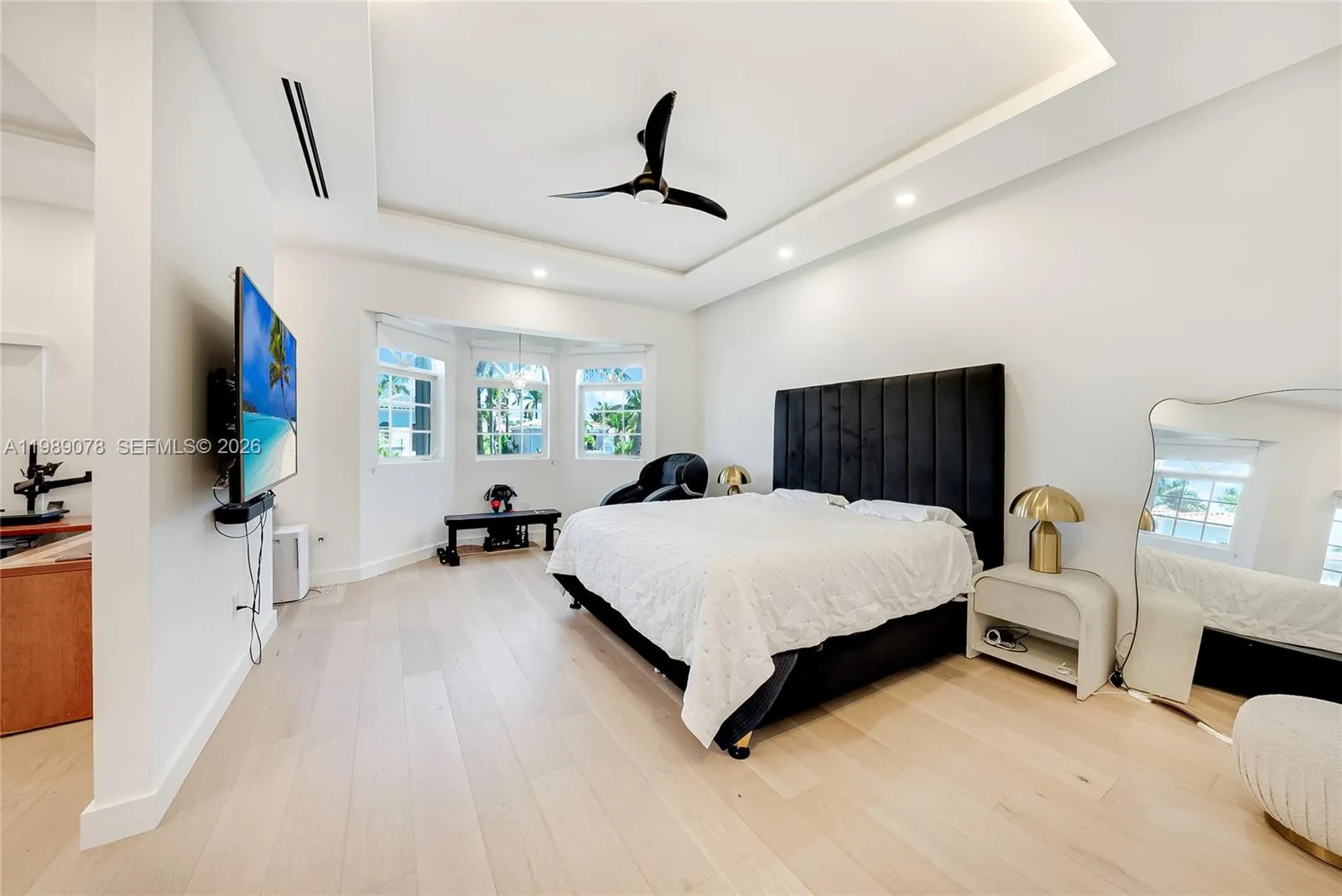 Open and luxurious primary bedroom with creative office/dressing area