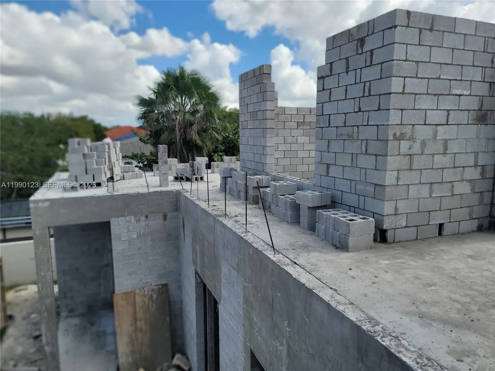 Installation of concrete blocks on second floor. The steel rebar is tied into the concrete walls and columns/tie-beams.  The intermediate slab between the first and second floor (roof) is made with 4,000 PSI reinforced concrete. It means it can withstand 4,000 pounds of force per square inch before failing. RESULT: A house engineered to withstand hurricanes, tornadoes and other natural disasters.