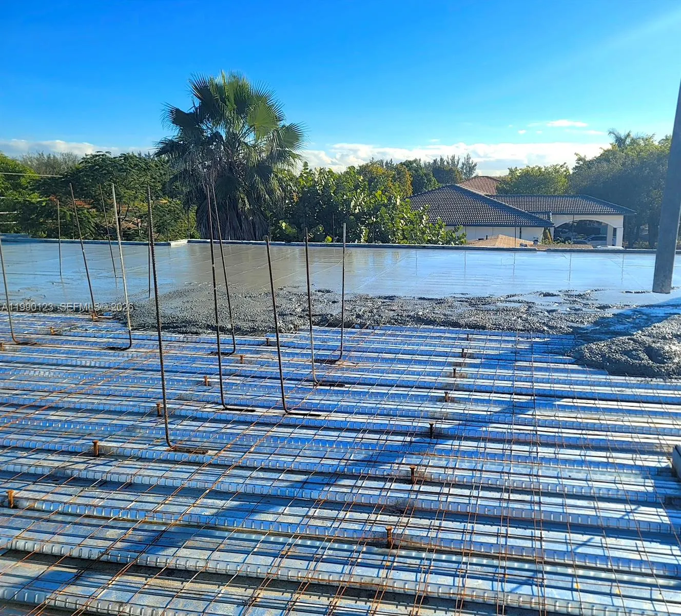 A TRUE MODERN BUNKER HOME- You are observing the roof concrete pouring, leveling and steel rebars installed on the flat reinforced concrete roof. RESULT: A house engineered to withstand hurricanes, tornadoes and other natural disasters. Flat reinforced concrete roofs last 50+ years with little maintenance.