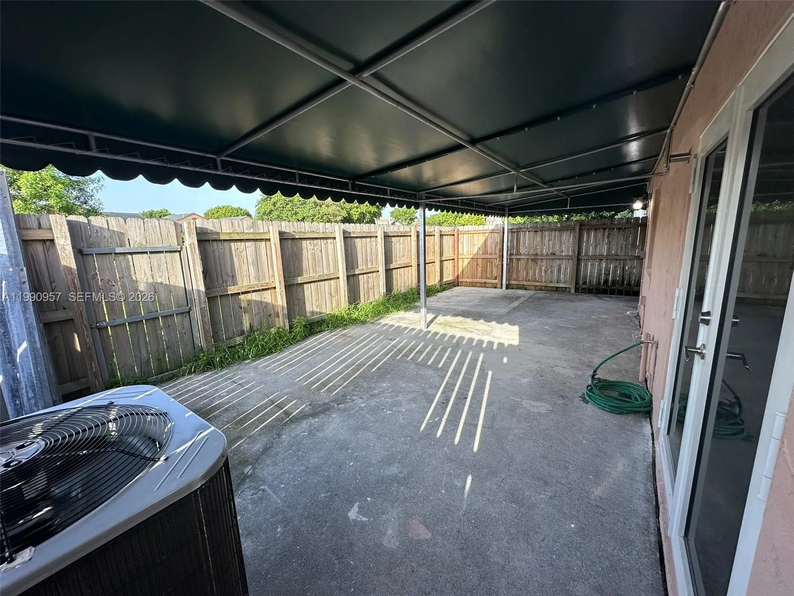 Cemented patio with terrace, and fence back door