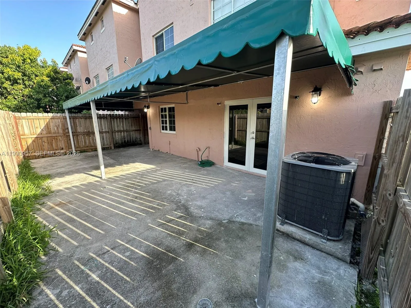 Cemented patio with terrace, and fence back door