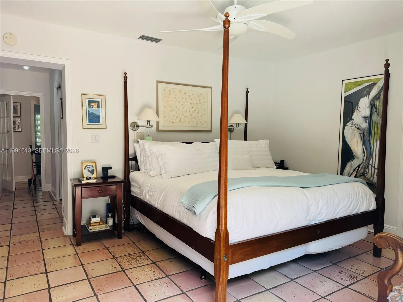 Master bedroom with sliding doors to lush garden and pool
