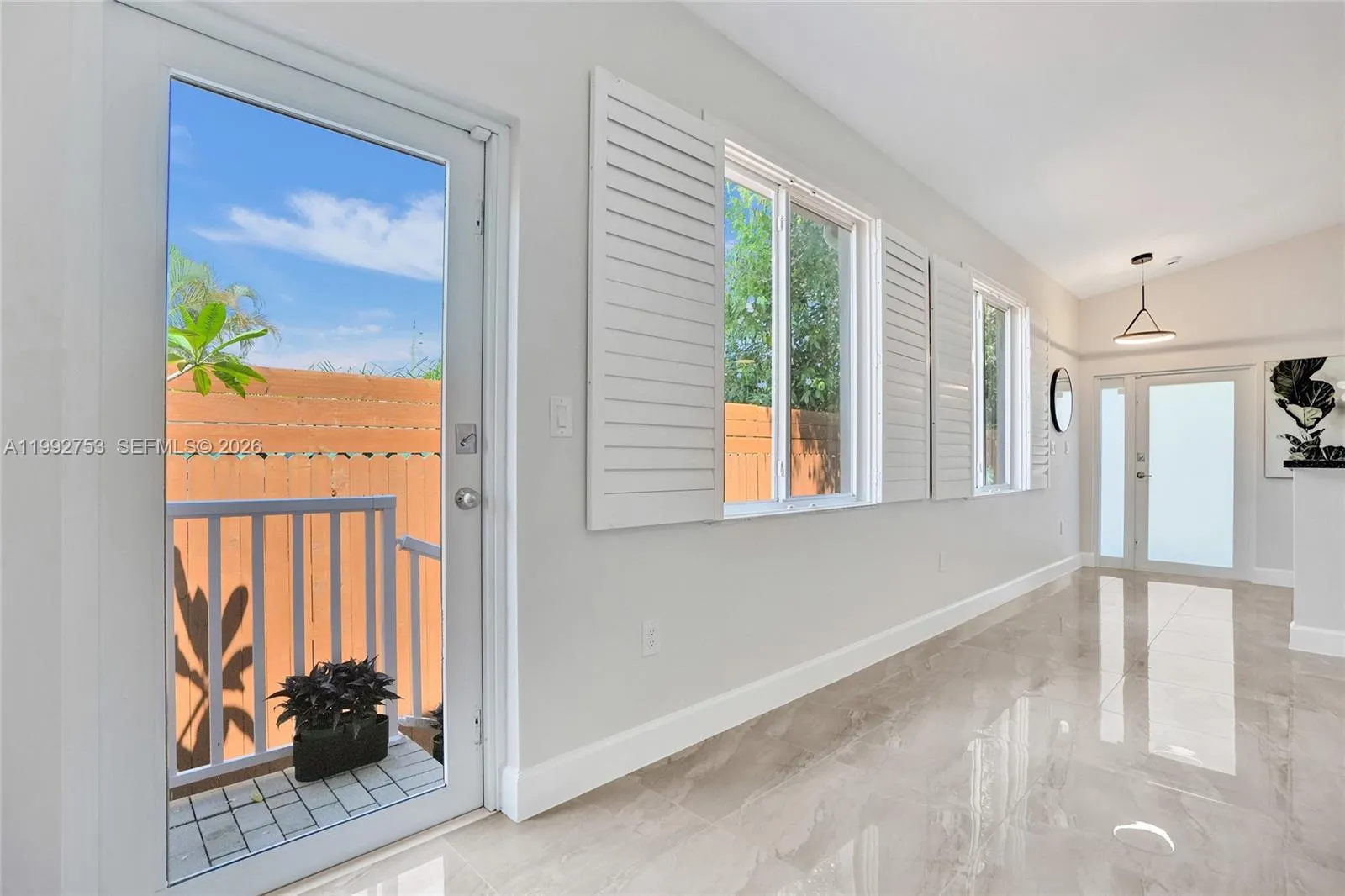 Side door to enclosed private space. (Hurricane impact door and windows)