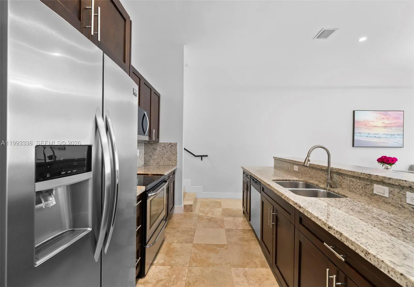Gourmet kitchen with granite countertops and breakfast bar.