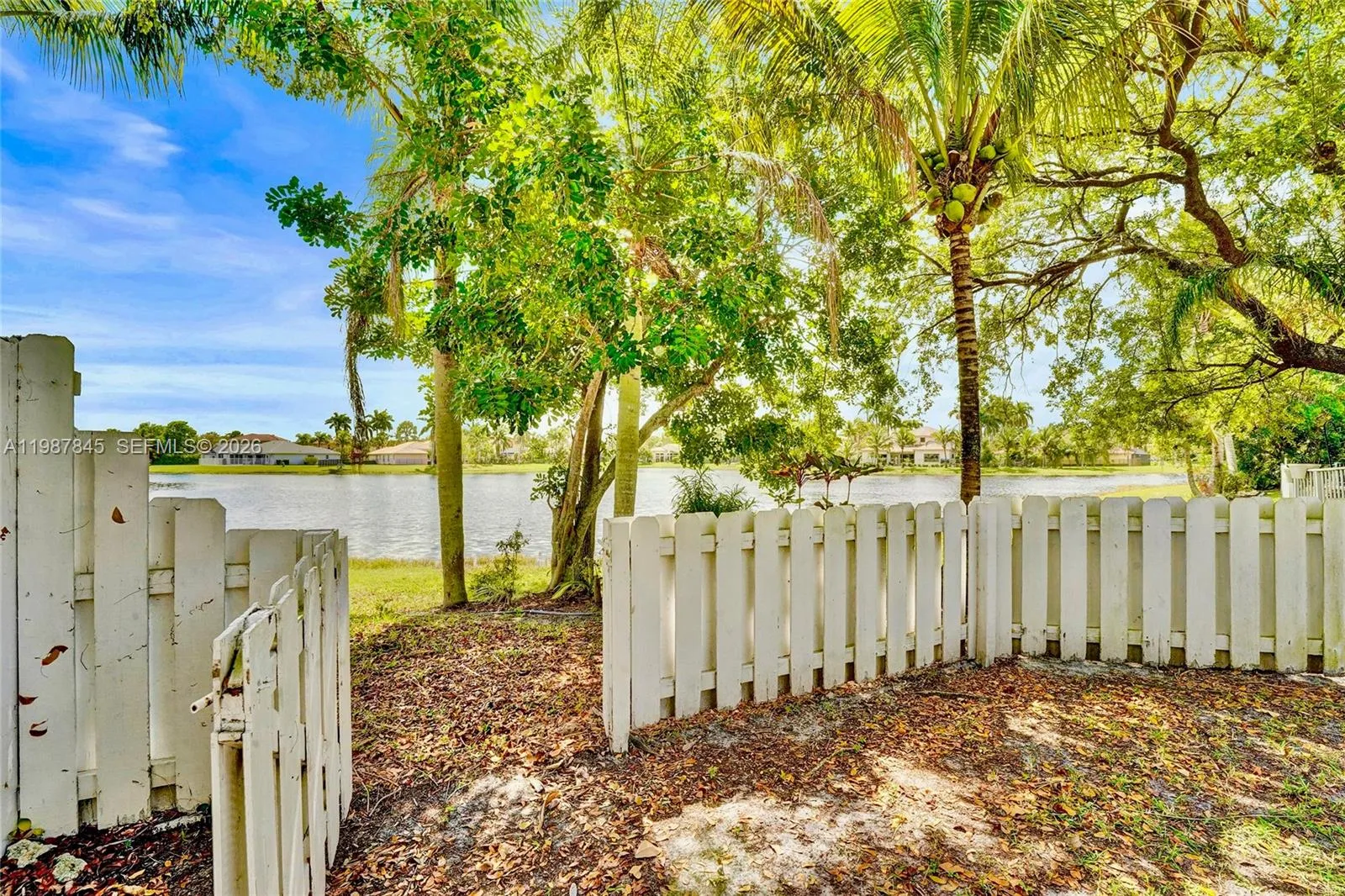 Gated opening leading to lake in backyard