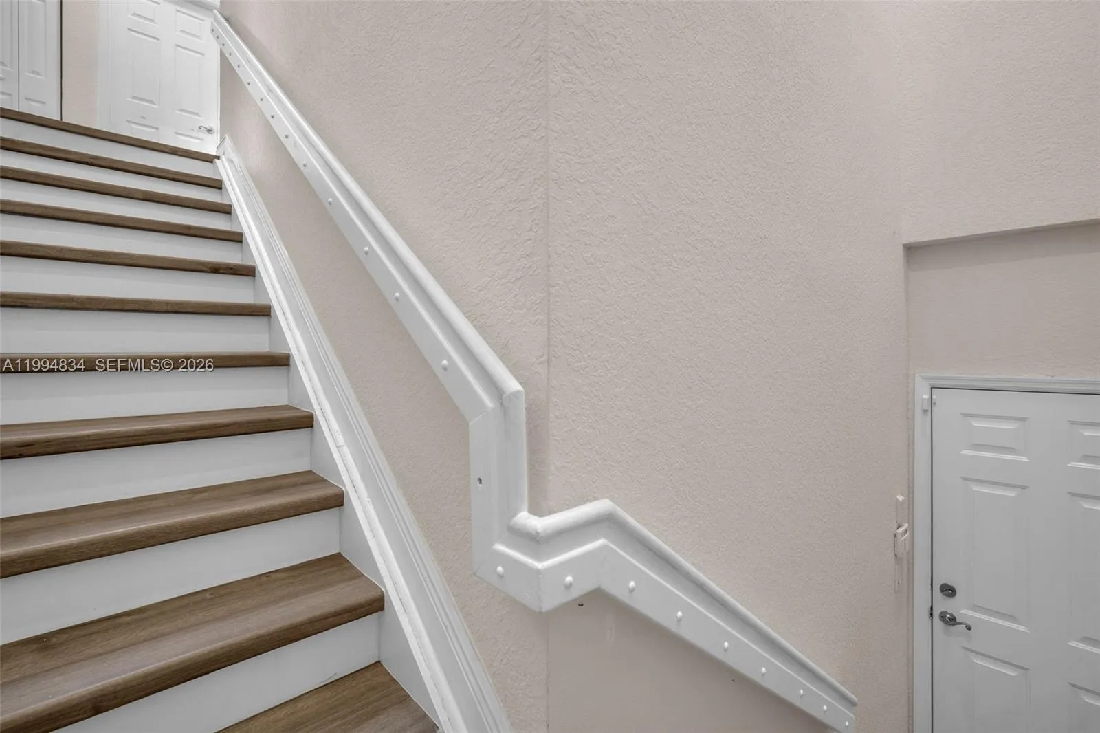Stairwell going to 1 car garage on 1st floor.
